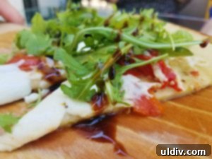 Elevate Your Weekend: Chicagoland's Best Events, Including Rooftop Magic 13 Clark flatbread with tomatoes, mozzarella, and arugula at AIRE