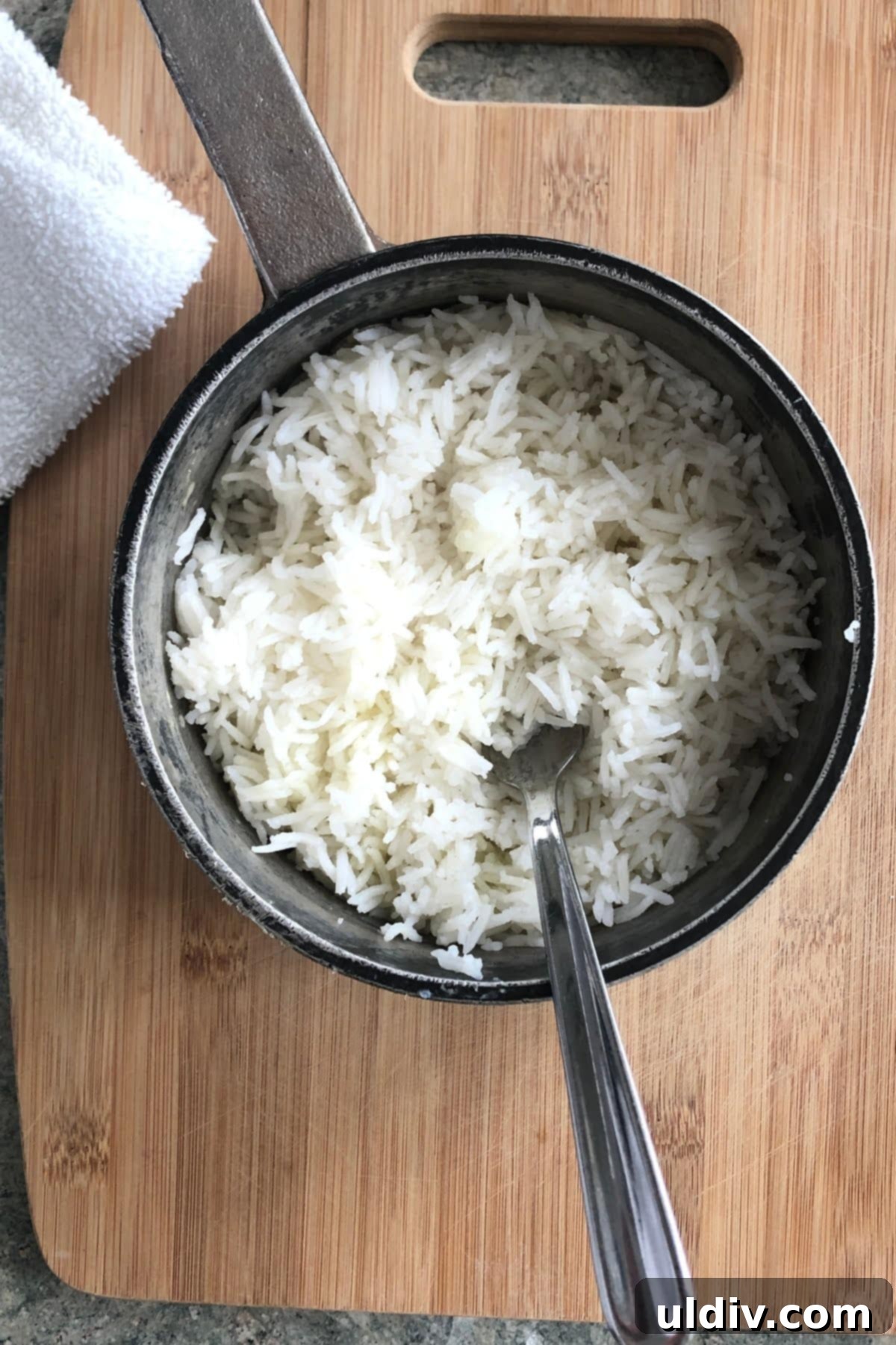 Unlock the Secret to Fluffy White Rice 3 a pot of freshly cooked white rice with a spoon.