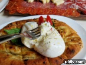 Forno Rosso Pizzeria: Pizza or Panuozzo? Why Not Both! 5 A generously sized burrata served on freshly baked focaccia, a perfect Italian appetizer.