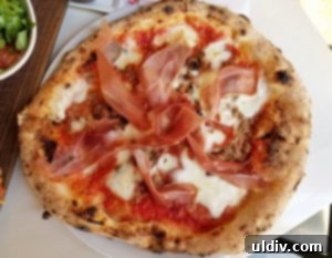 Forno Rosso Pizzeria: Pizza or Panuozzo? Why Not Both! 7 A delicious Neapolitan Tre Carne pizza, showcasing its thin crust and generous toppings.