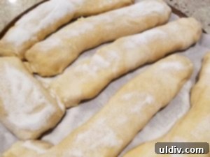 Nielsen-Massey Review & Giveaway: Elevating Every Baked Delight 5 Strudel dough rolled into cylinders and sprinkled with sugar, ready for baking.