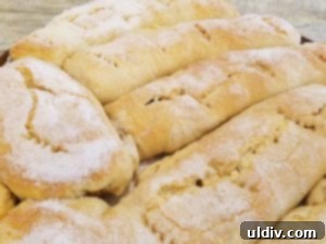 Nielsen-Massey Review & Giveaway: Elevating Every Baked Delight 6 Slices of orange ricotta strudel arranged on a plate, garnished with powdered sugar and orange zest.