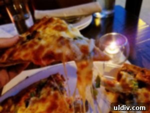 Angelo's Wine Bar: My Roman Rhapsody of Flavors 10 Close-up of a slice of pizza with melted mozzarella