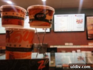 A display of Zoup!'s diverse soup menu with various choices.