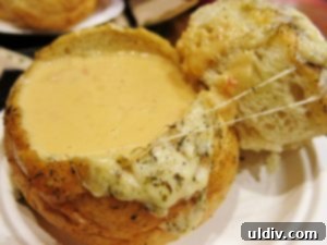 A delightful bowl of Zoup!'s lobster bisque in a parmesan garlic bread boule.