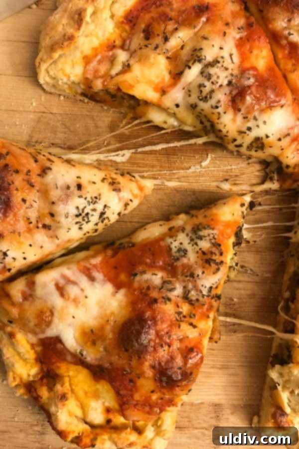 Mastering Authentic Stuffed Pizza 4 Three generous slices of stuffed pizza with rich, melting mozzarella cheese visible between the crusts.