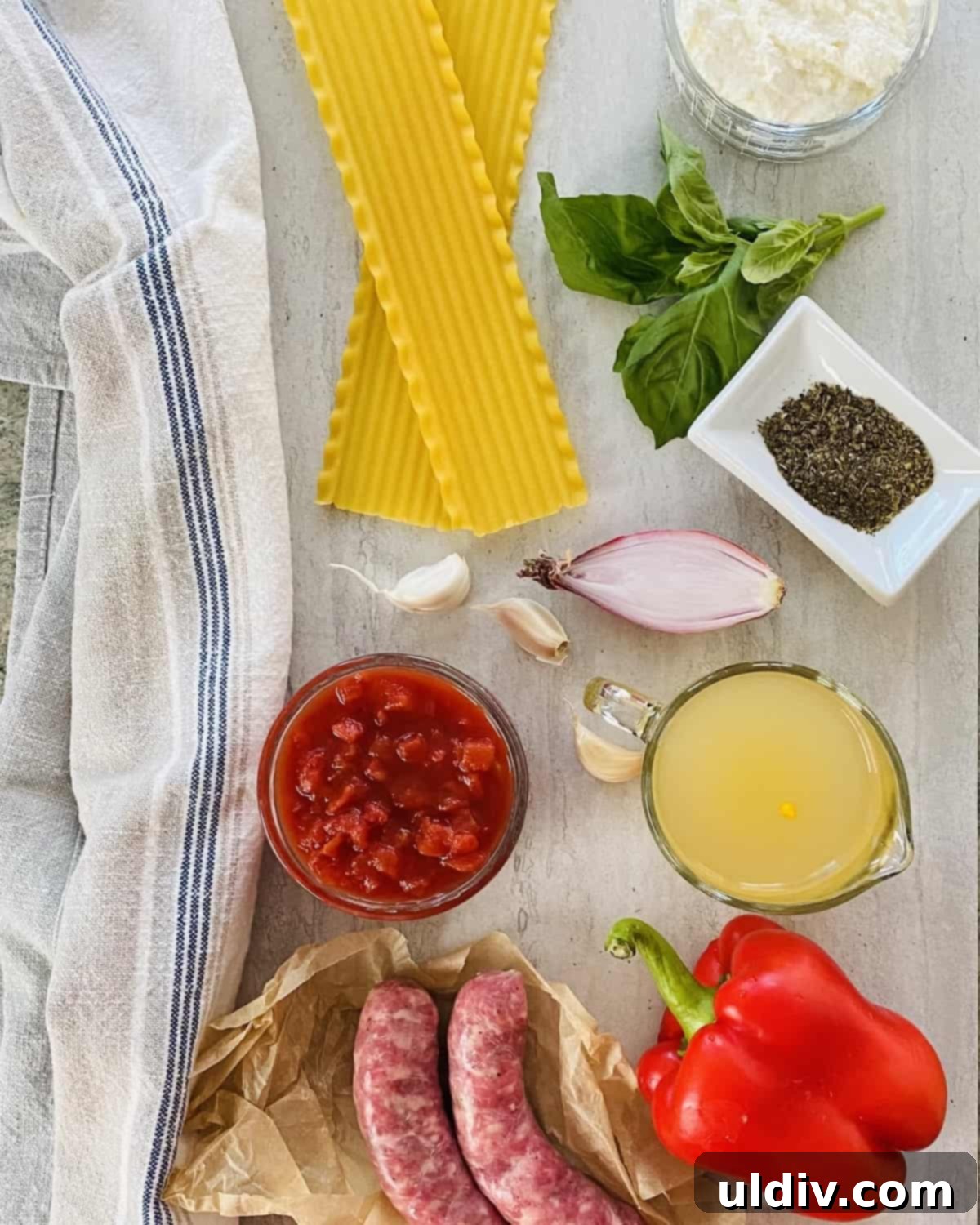 Easy One Pot Lasagna Soup 3 Lasagna noodles, chicken stock, red pepper, ricotta cheese, garlic, diced tomatoes laid out as ingredients.