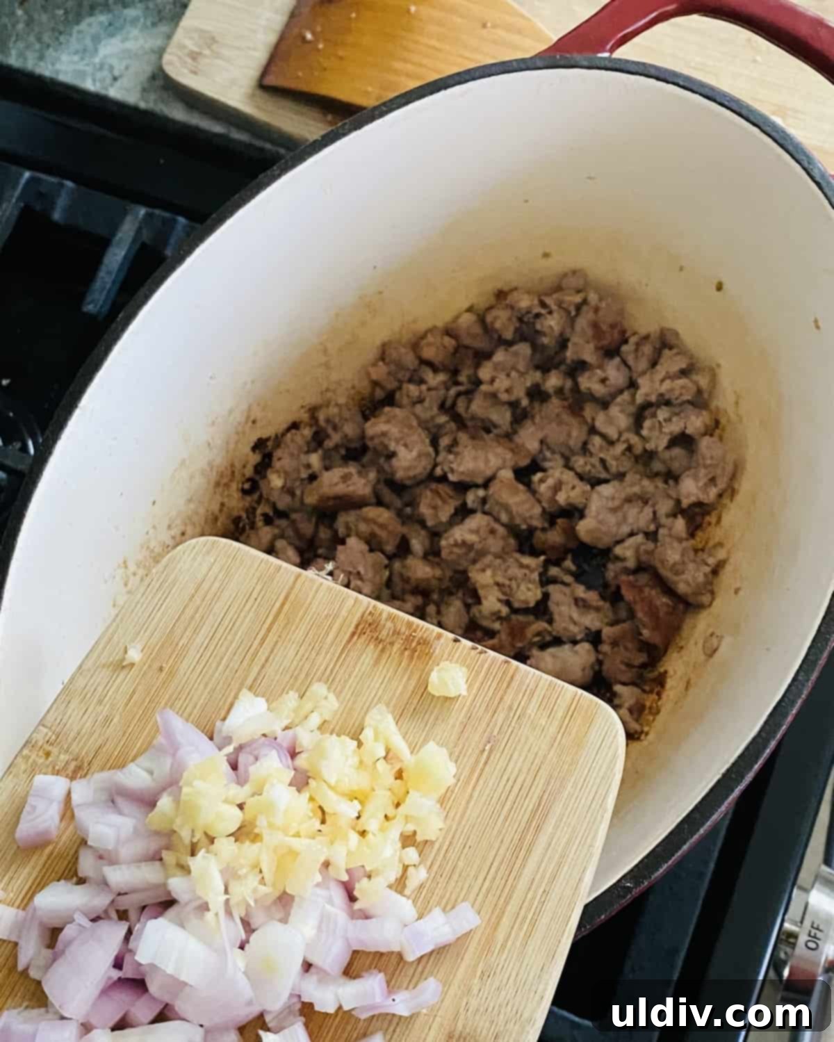Easy One Pot Lasagna Soup 5 adding chopped shallot and garlic to cooked Italian sausage.