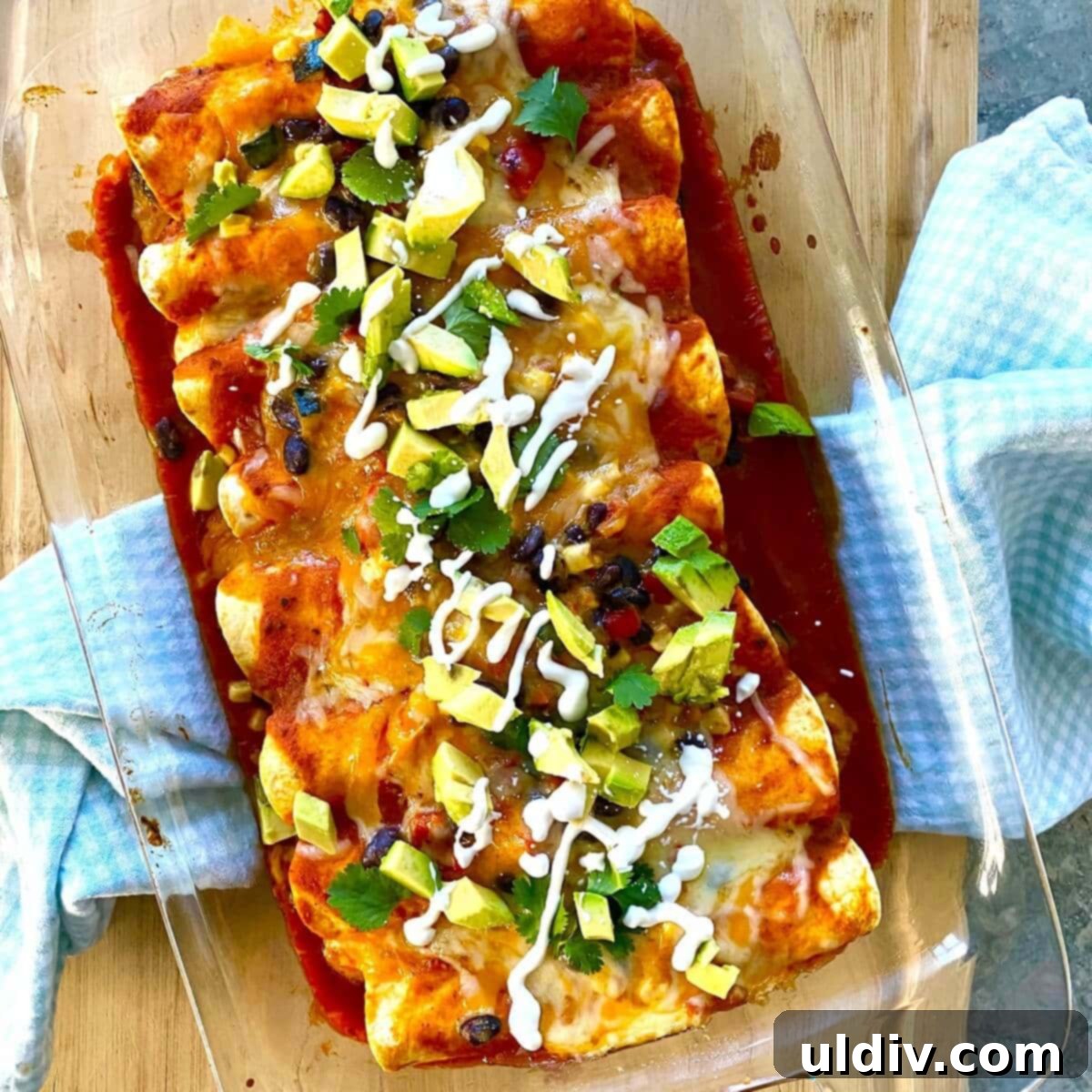 Simple Wholesome Black Bean Enchiladas 10 A baking pan filled with golden-brown, freshly baked enchiladas, topped with perfectly melted cheese, bubbling and ready to serve.