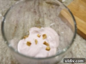 Quinoa Parfait Recipe Wellness in Every Bite 9 First layer of quinoa pudding in a glass, followed by strawberry Greek yogurt, filberts, and sliced strawberries