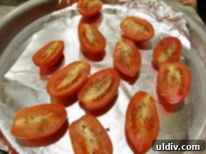 Delicious by Any Other Name 5 Halved Roma tomatoes arranged in a pan, seasoned and ready for oven roasting, essential for Zacusca.