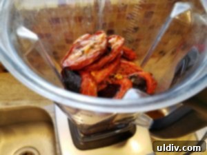 Delicious by Any Other Name 7 A blender filled with peeled roasted eggplant, deseeded bell peppers, and roasted tomatoes, ready to be pureed for Zacusca.