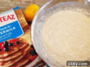 Fresh lemon zest being grated into pancake batter