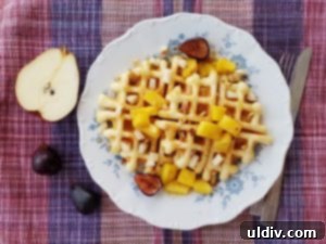 Belgian waffles topped with caramelized pineapple, roasted figs, and red pear