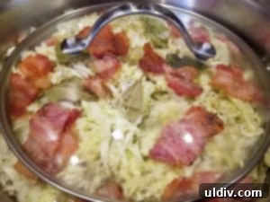 Easter's Heartwarming Cabbage Rolls A Tale of Tradition 13 Diced tomatoes being spread evenly over the cooking cabbage rolls
