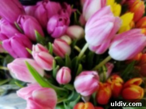Wishing You a Joyous Easter 2 A vibrant Easter basket filled with colorful eggs, fresh spring flowers, and green grass, symbolizing joy and new beginnings.