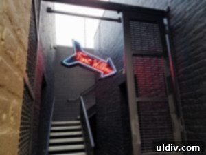 Fort Willow: A Culinary Journey of Boldness and Unforgettable Moments 3 Subtle neon sign guiding visitors to the hidden entrance of Fort Willow restaurant on Elston Avenue