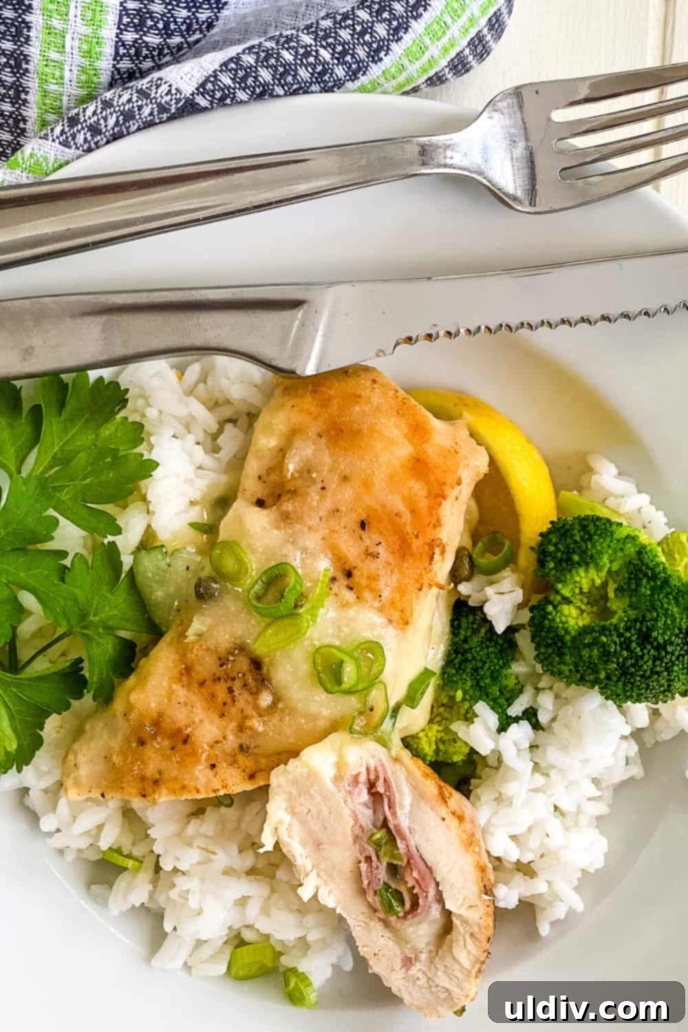 Prosciutto Provolone Chicken Roulade with Zesty Lemon Wine 2 Delicately sliced Prosciutto and Provolone Stuffed Chicken, showcasing the creamy cheese and savory ham inside, served with a vibrant lemon wine sauce.