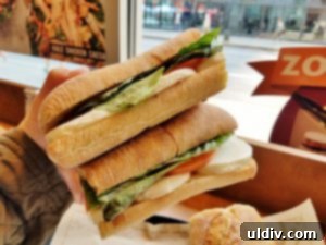 Summer Chill Shakes and Gazpacho 6 A delicious half of Zoup!'s MTB sandwich, showcasing fresh mozzarella, tomato, and basil.
