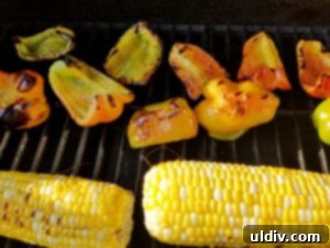 Grilled Veggie Panino Still My First Flame 3 Grilled bell peppers, tomatoes, and corn cooling on a white plate