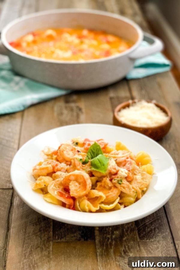 Seared Shrimp with Blistered Tomato Sauce and Crumbled Goat Cheese 5 A bowl of shrimp with tomato sauce and a serving dish.