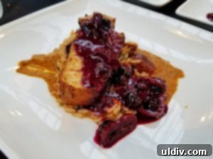 Culinary Fight Club Finale: Pork, Pastry, and Pure Passion 6 A close-up view of Chef Ryan Rondeno's innovative pork and blueberry dish, showcasing the unique flavor combination.