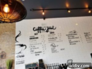 World-Class Coffee & Sandwiches: Exquisite Flavors, Just Around the Corner 3 Artistically designed menu on ceramic tiles at Coffee Joint, showcasing various fonts and a hand-painted aesthetic that complements the cafe's decor.