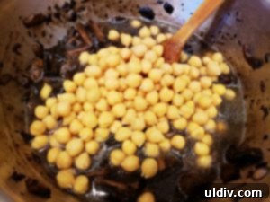 Drained chickpeas added to the pan