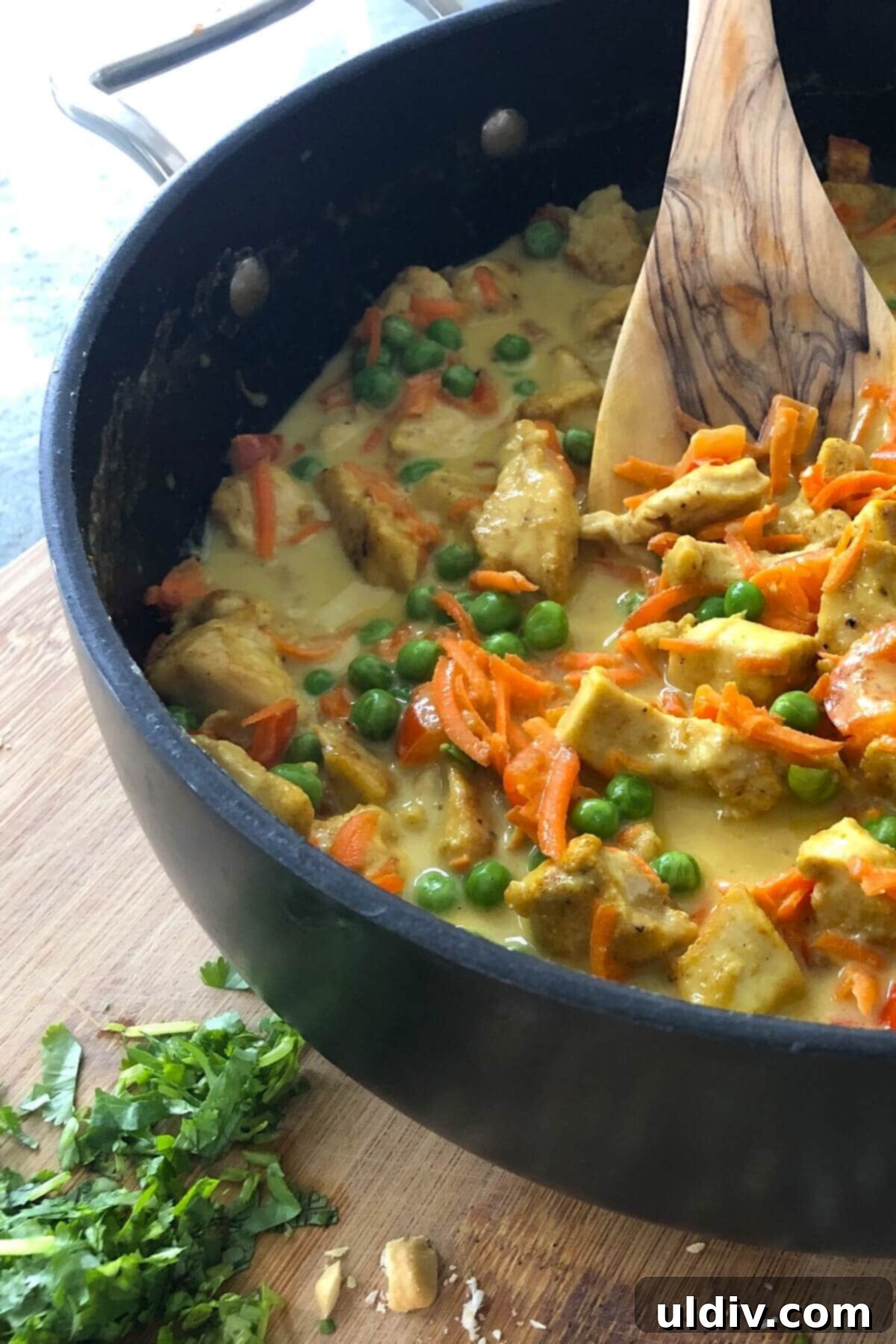 Creamy Thai Coconut Chicken Curry 9 A large sauté pan brimming with finished Thai chicken curry, ready to be served.