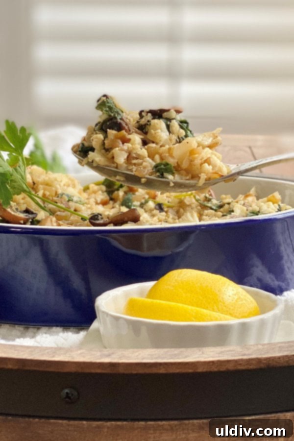 Easy 20-Minute Cauliflower Pilaf 6 A vibrant vegetarian side dish featuring cauliflower rice pilaf, rich with green spinach and earthy mushrooms, ready to be enjoyed.