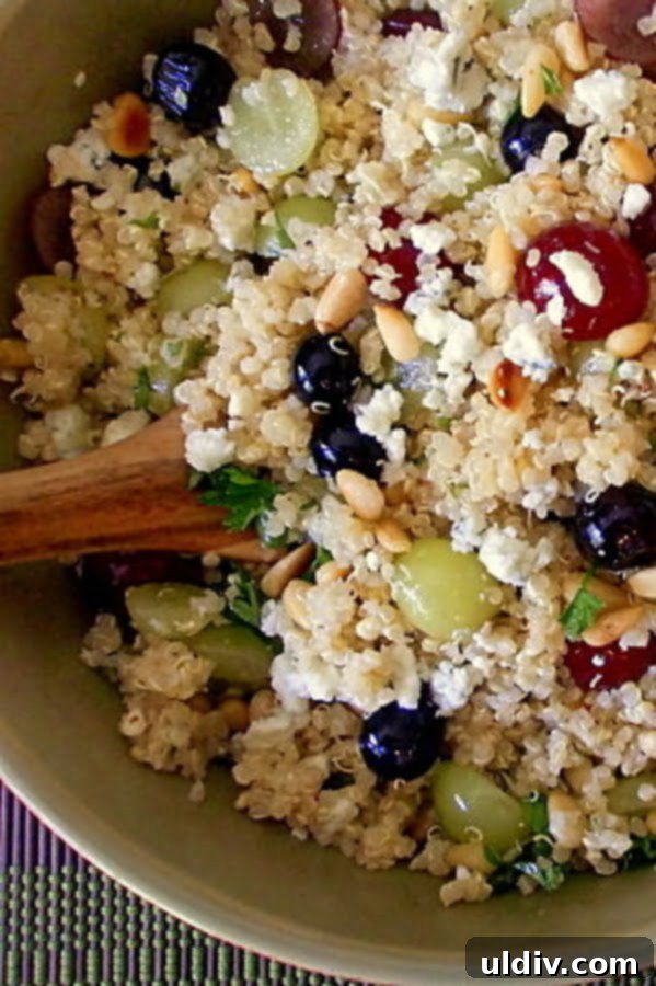 Tropical Quinoa Salad with Berries and Pine Nuts 3 A cool, refreshing and delicious fruit quinoa salad with grapes, blueberries, pine nuts and an apple cider vinaigrette will be a welcome addition to any menu. #quinoa #quinoasalad #fruitquinoa #healthyrecipe #blueberries #healthysidedishrecipe