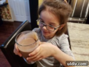 Hope & Sesame Waffle Recipe, Review, and Mother's Day Giveaway 6 A child enthusiastically enjoying a glass of Hope & Sesame chocolate sesamemilk