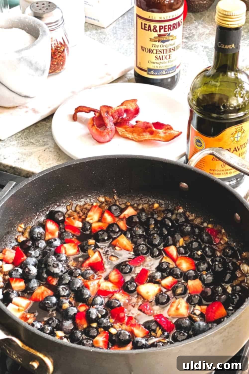 Berry Bacon Glazed Grilled Pork Tenderloin 4 A rich, chunky berry bacon sauce simmering in a pan, ready to be served with grilled pork.