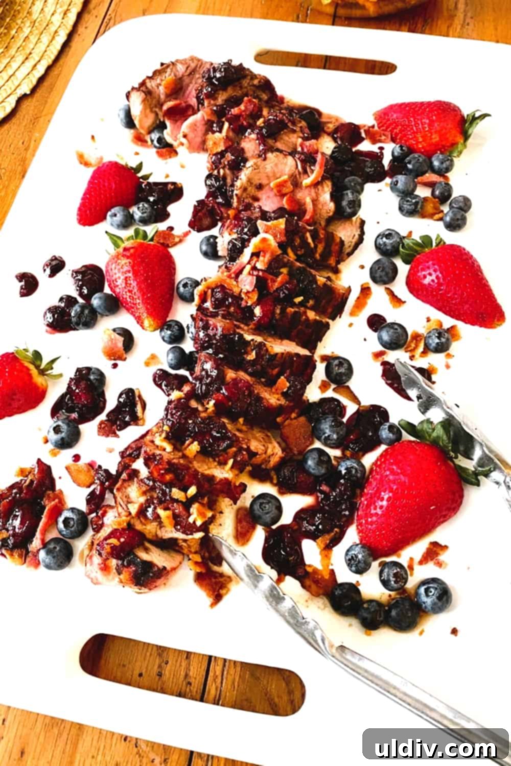 Berry Bacon Glazed Grilled Pork Tenderloin 6 Close-up of tender, sliced pork tenderloin, glistening with a generous dollop of the homemade berry bacon sauce.