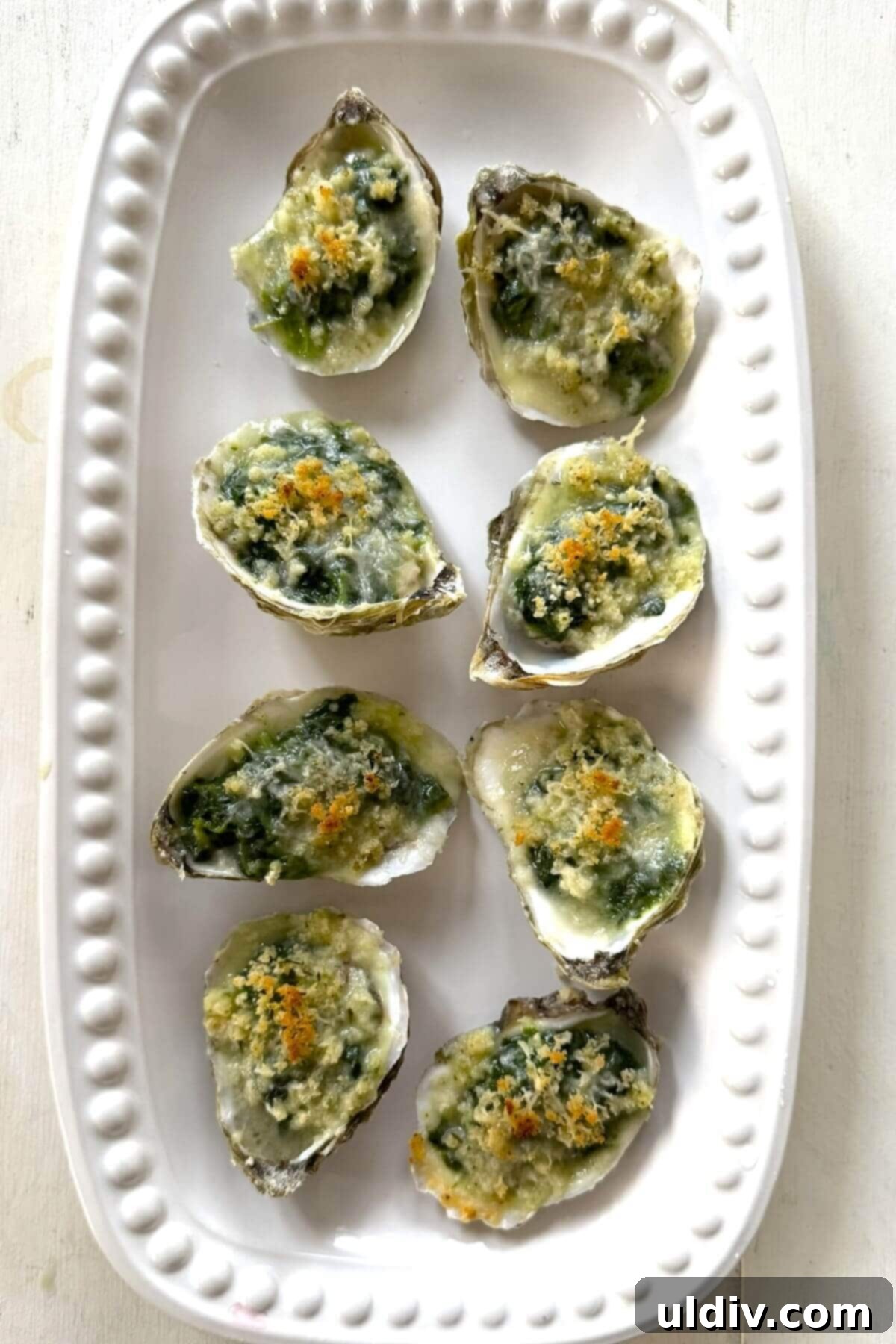 Indulgent Oysters Rockefeller 12 A plate of oysters Rockefeller for serving.