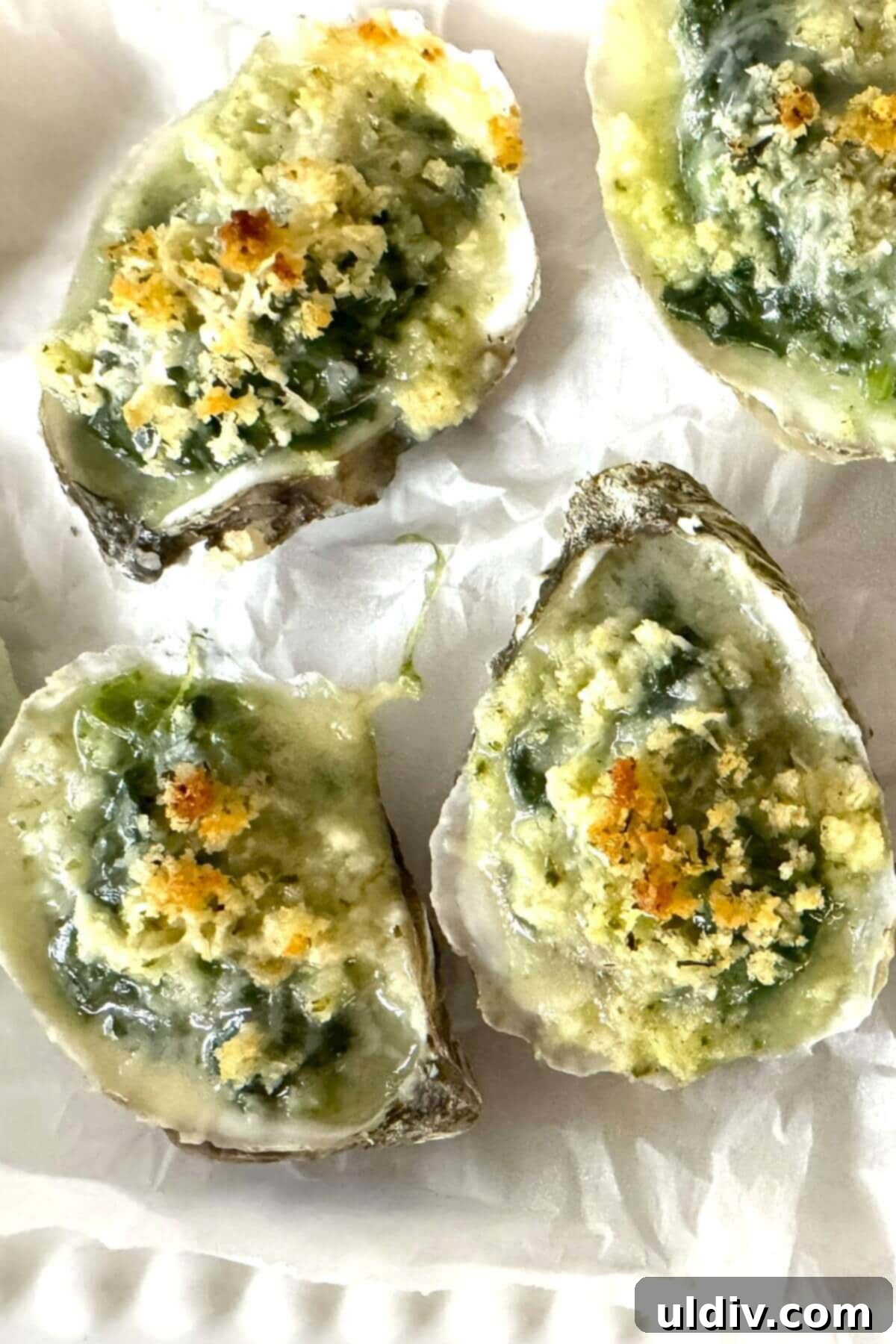 Indulgent Oysters Rockefeller 3 4 baked oysters Rockefeller style on a plate.