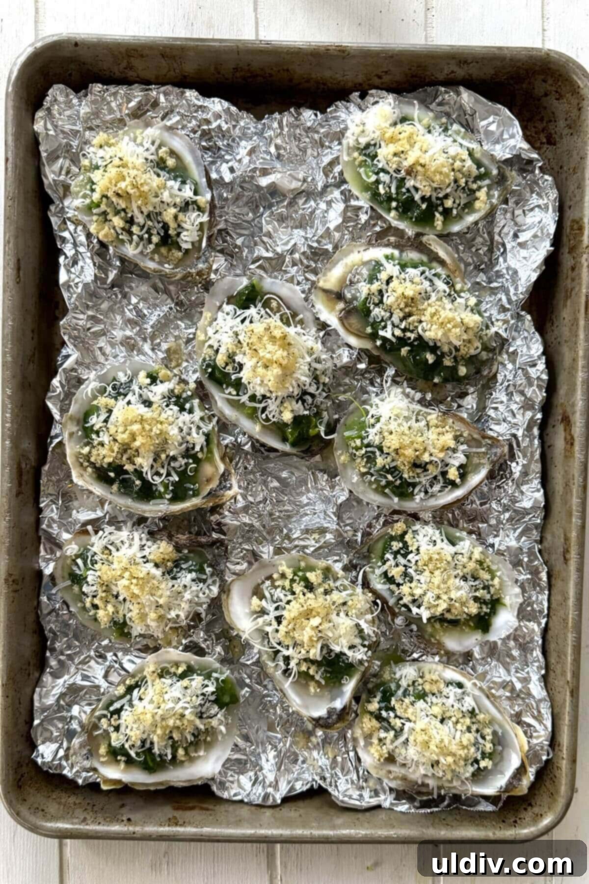Indulgent Oysters Rockefeller 10 Baked oysters Rockefeller on crumpled foil.