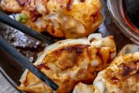 Crispy Pork Potstickers: Homemade Dumplings with Ginger Soy Dipping Sauce