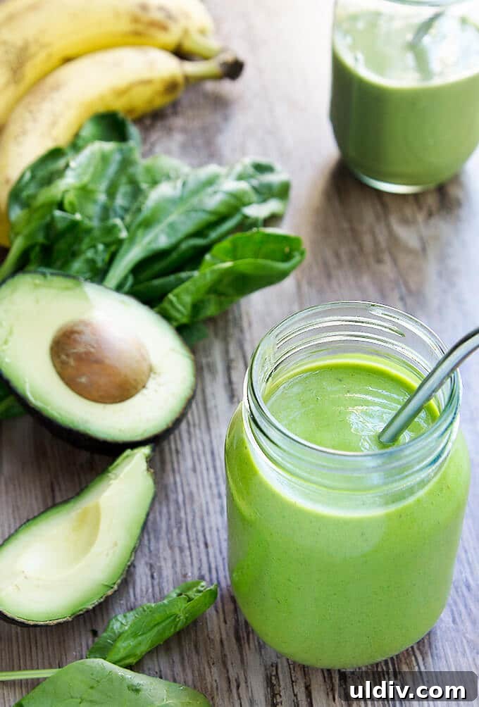 Refreshing Green Smoothie Recipes for Energy and Detox 4 Green smoothie next to avocado spinach and bananas.