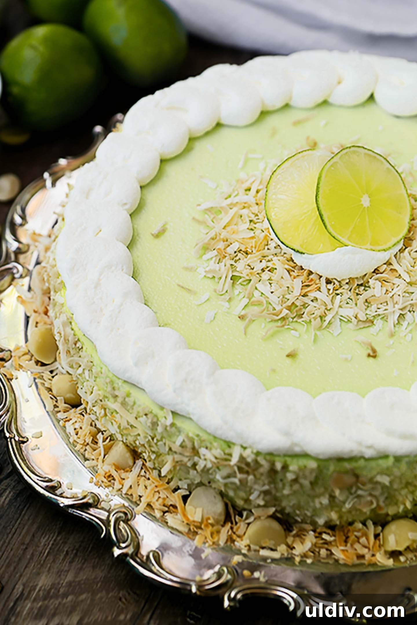Tangy Key Lime Cheesecake Recipe with Graham Cracker Crust 2 key lime cheesecake with whipped cream and toasted coconut.