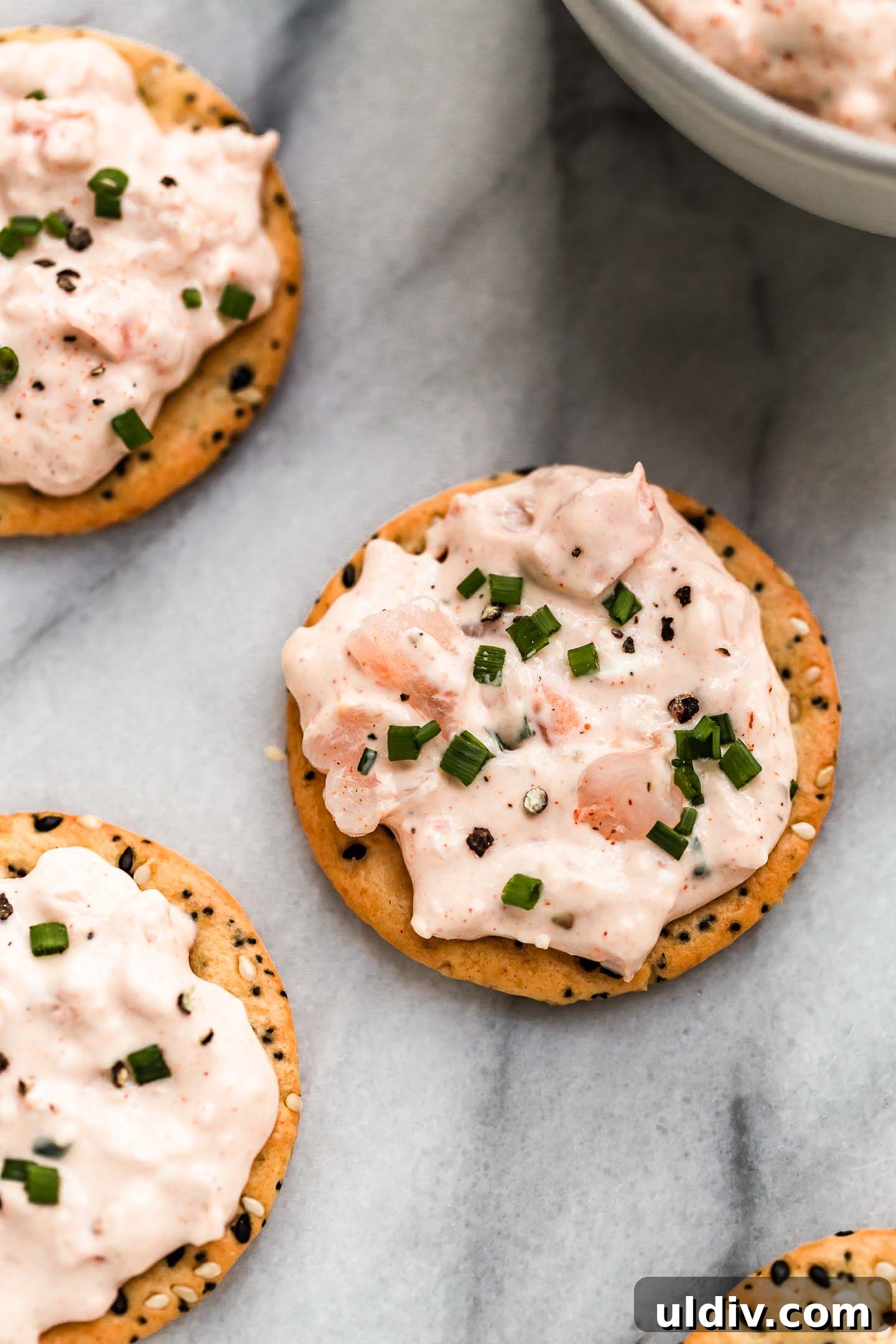 Creamy Pink Shrimp Dip Recipe for Parties and Appetizers 2 pink shrimp dip on crackers.