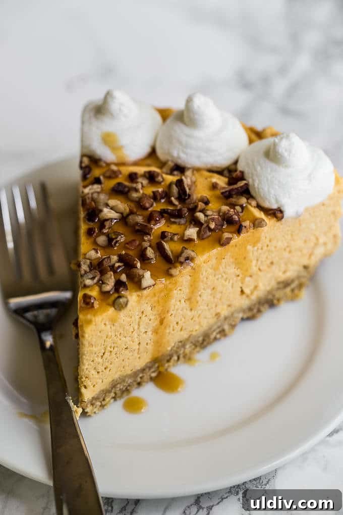 No-Bake Pumpkin Cheesecake Recipe: Creamy Fall Dessert 2 Slice of pumpkin cheesecake on a plate with a fork.