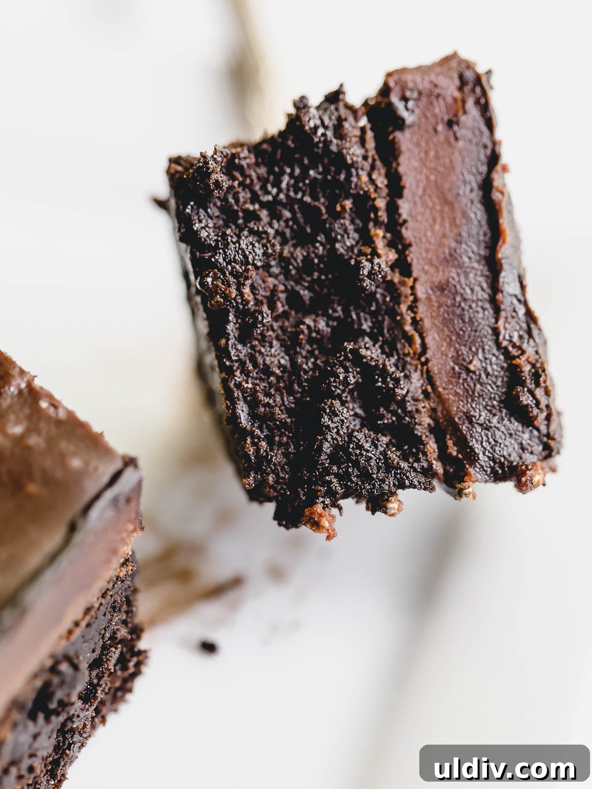Decadent Flourless Chocolate Cake Recipe for Rich, Gluten-Free Dessert 3 A picture showing the layers of the cake on a fork.