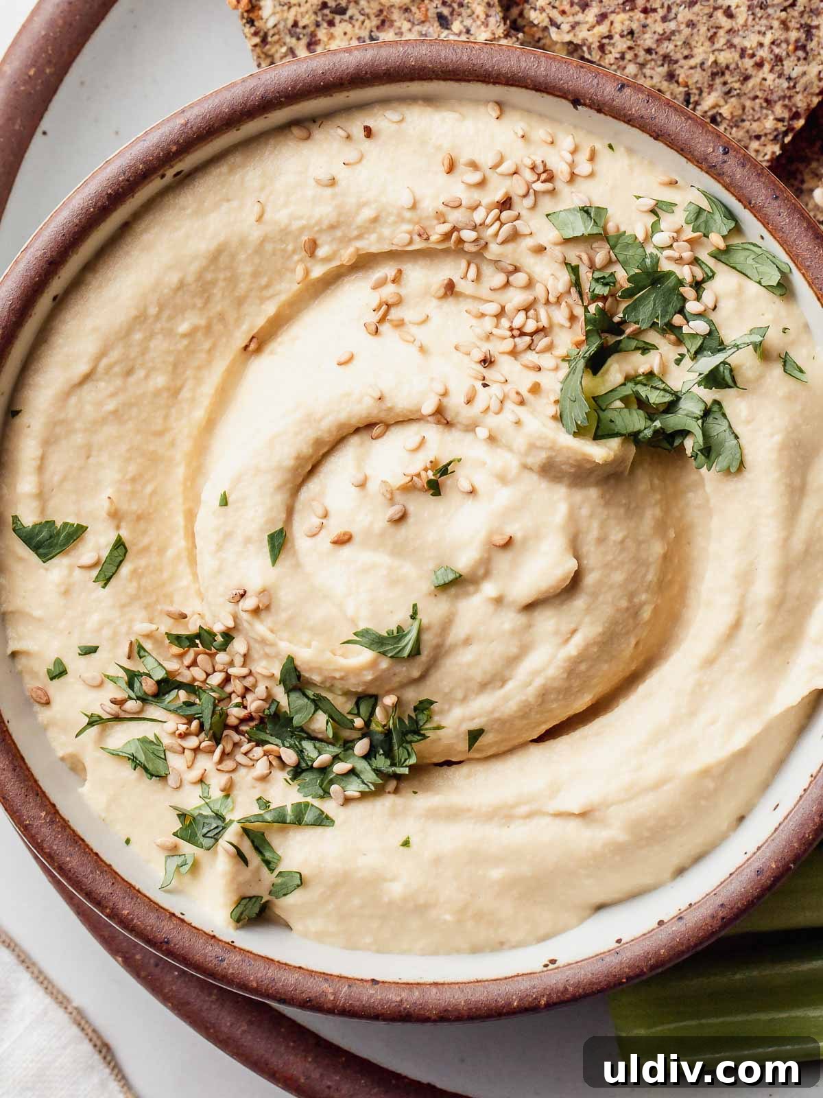 Oil-Free Hummus Recipe: Creamy Chickpea Dip Without Oil 2 Oil free hummus in a bowl with sesame seeds on top.