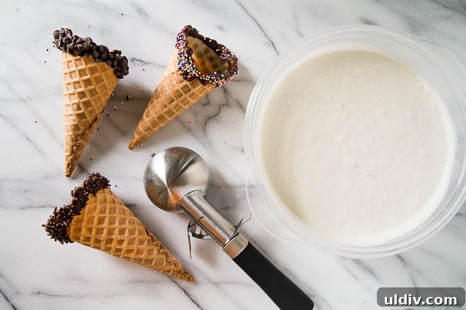 Creamy No-Churn Ice Cream Recipe: 5-Minute Homemade Dessert 3 3 waffle cones dipped in chocolate next to vanilla ice cream