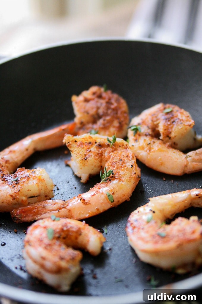 Blackened shrimp for Cajun Shrimp Chowder. Shrimp in a frying pan.