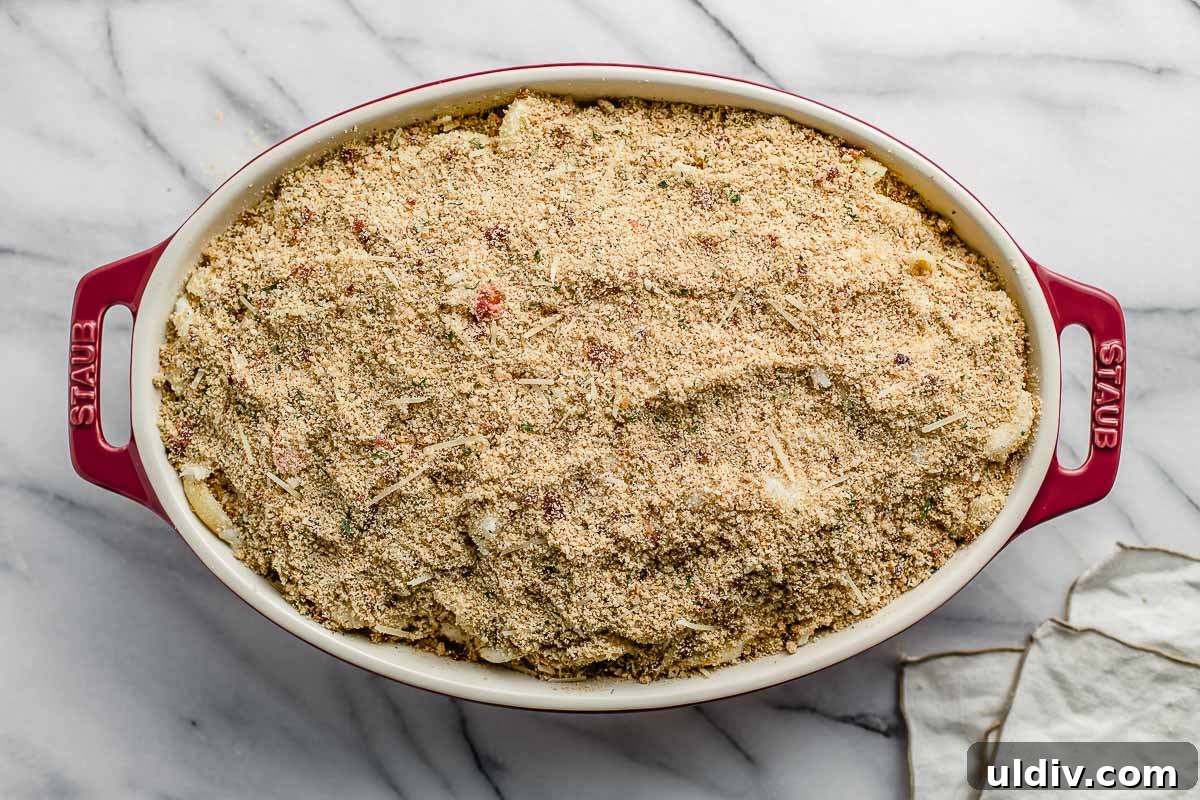 Creamy Lobster Macaroni and Cheese with Parmesan Crust 7 Lobster mac and cheese in a casserole dish with breadcrumbs.