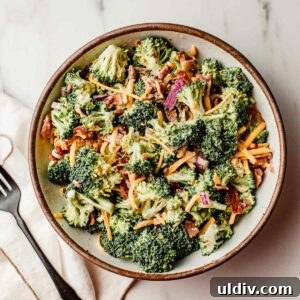 Keto Broccoli Salad with Bacon, Cheddar & Creamy Dressing 6 Broccoli salad in a bowl with a fork.
