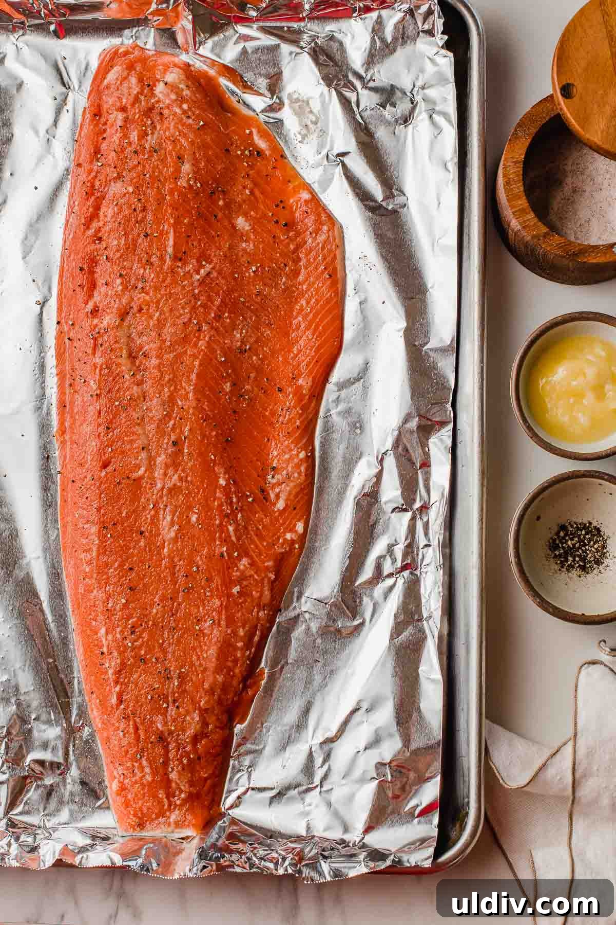 Oven-Baked Salmon with Lemon Herb Glaze 3 A salmon fillet on a baking sheet.