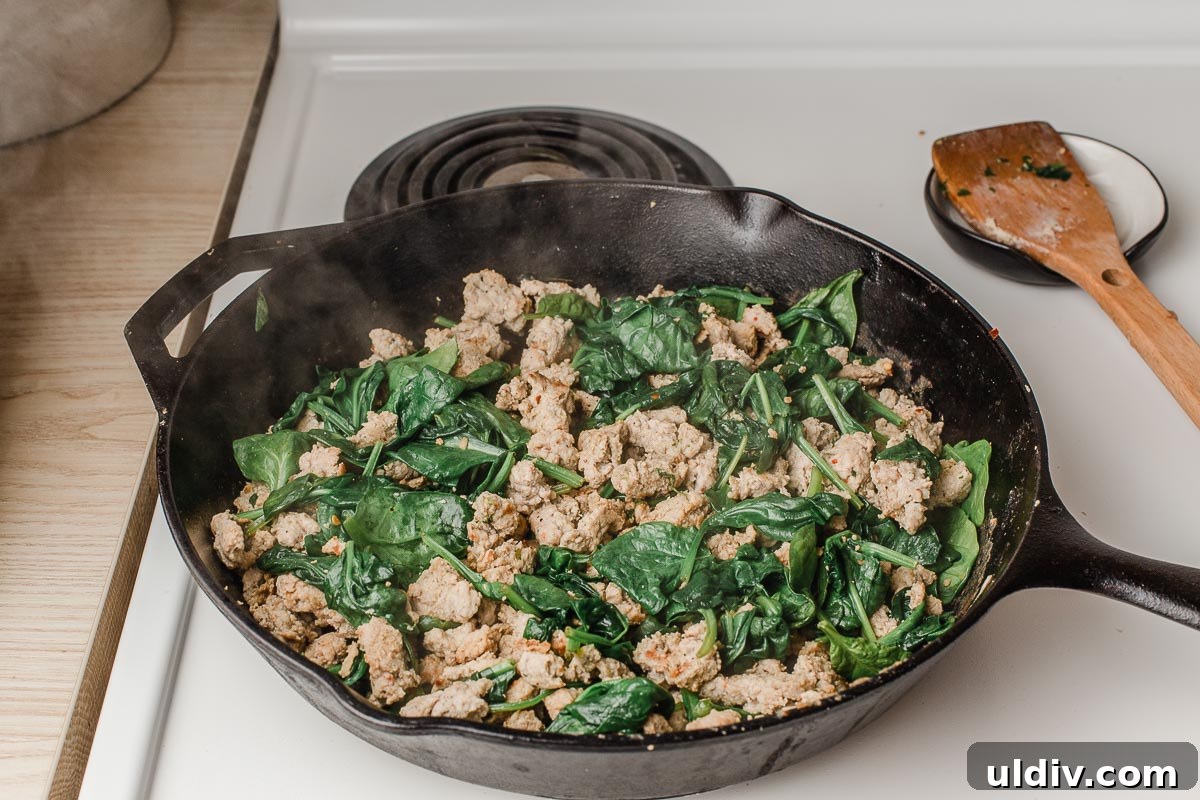 Turkey Sausage and Spinach Frittata Recipe for Weeknight Breakfast 4 The spinach wilting in the skillet.
